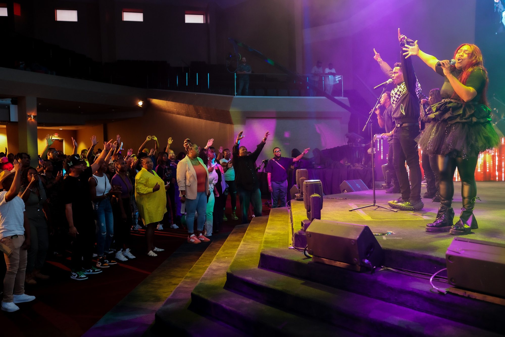 Congregation worshiping with hands raised